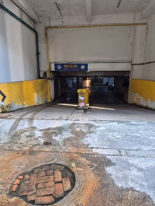 You will see an entrance to the basement carpark